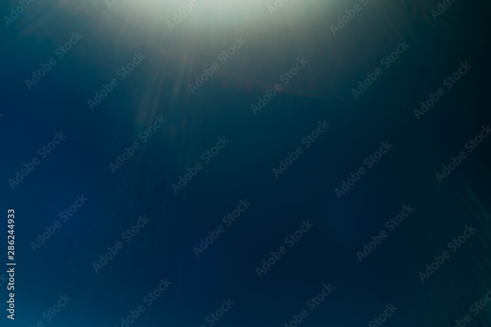 Obraz premium Blur light rays. Teal blue abstract art background. Lens flare glow. Sunlight effect.