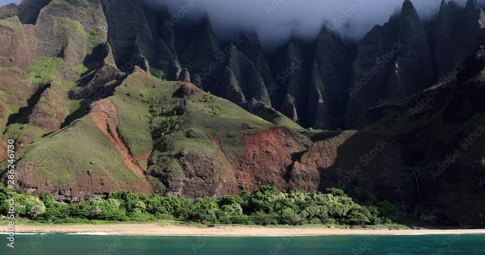 Hawaii, Kauai famous Na pali coast beach view from water. Famous Hawaiian travel destination. Napali coastline in Kaui, Hawaii, USA, the Honopu arch. Majestic awesome landscape.