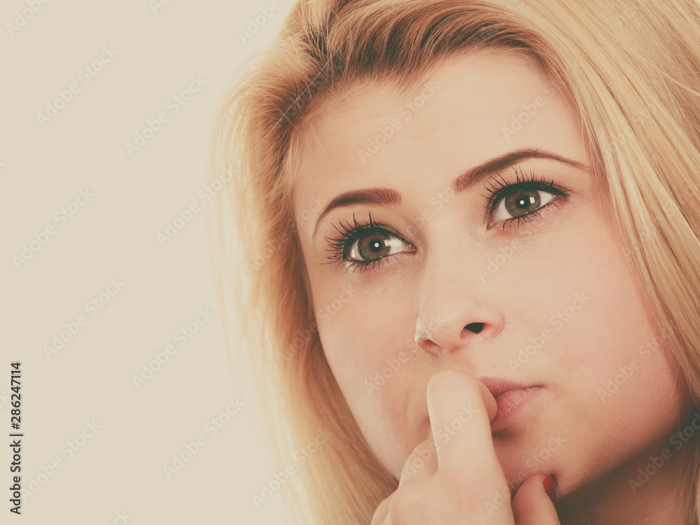 Naklejka premium Attractive blonde woman thinking and contemplating