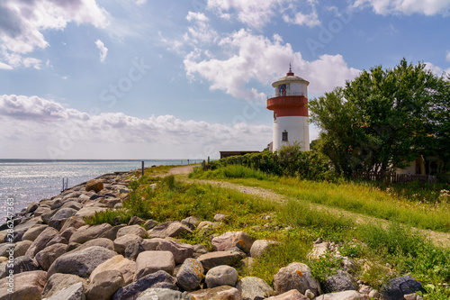 Fototapeta Naklejka Na Ścianę i Meble -  Small lighthouse with a footpath and the coast of the Baltic Sea on the island langeland