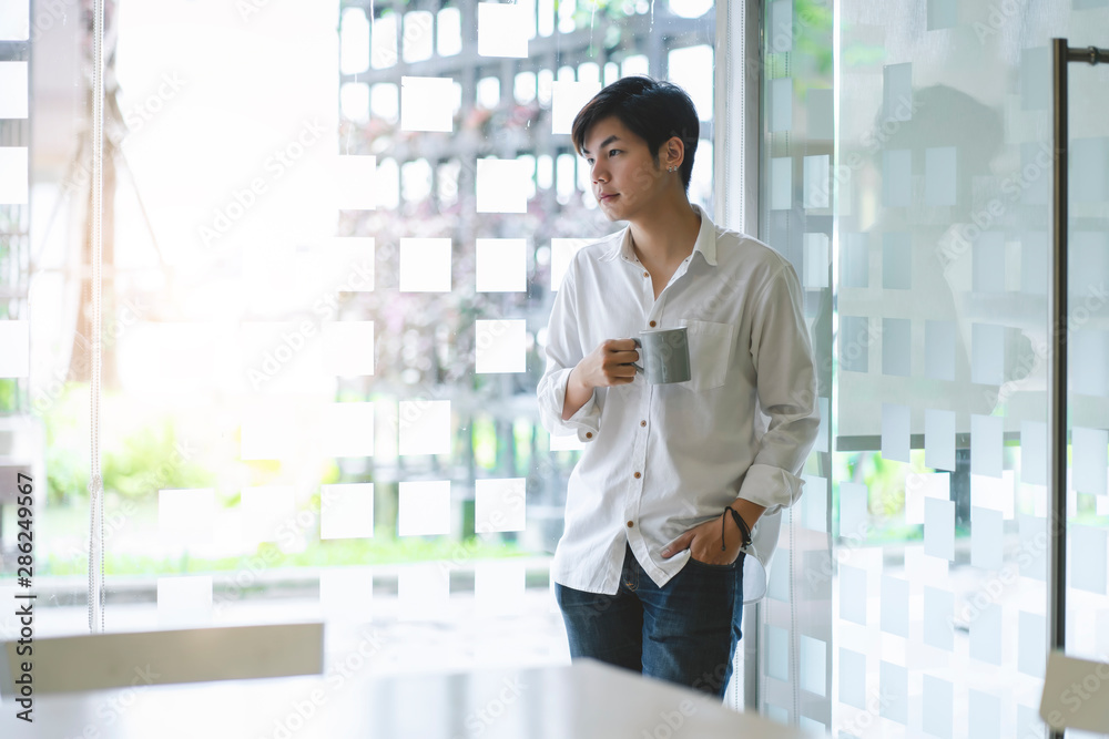 Portrait of casual young entrepreneur businessman working in modern work station. Portrait of casual young entrepreneur businessman working in modern work station.