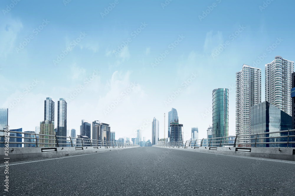 Asphalt road with modern building and skyscrapers Asphalt road with modern building and skyscrapers