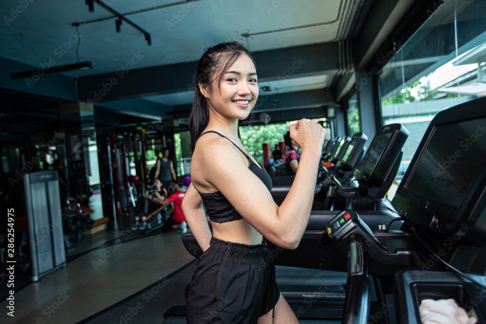 Women jogging on the treadmill in the gym Women jogging on the treadmill in the gym