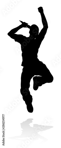 A singer pop, country music, rock star or hiphop rapper artist vocalist singing in silhouette