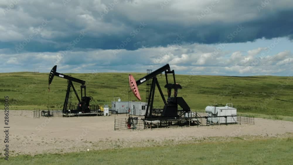 Aerial Drone Shot of Alberta Oil Pumps on a Clear Summer Day in the