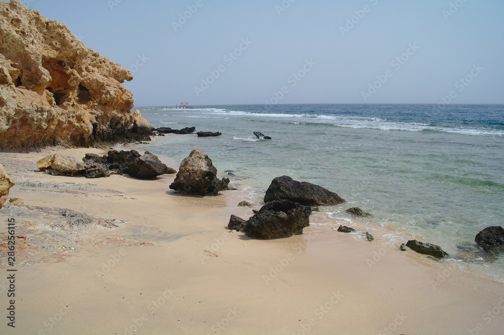 Beautiful azure red sea with waves and rocks and clear blue sky in Egypt