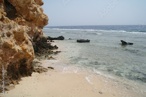 Beautiful azure red sea with waves and rocks and clear blue sky in Egypt