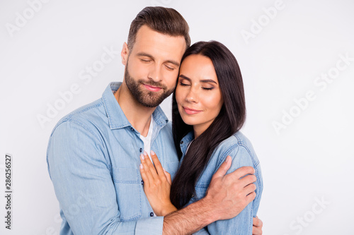 Portrait of charming people having long hair closed eyes hugging isolated over white background