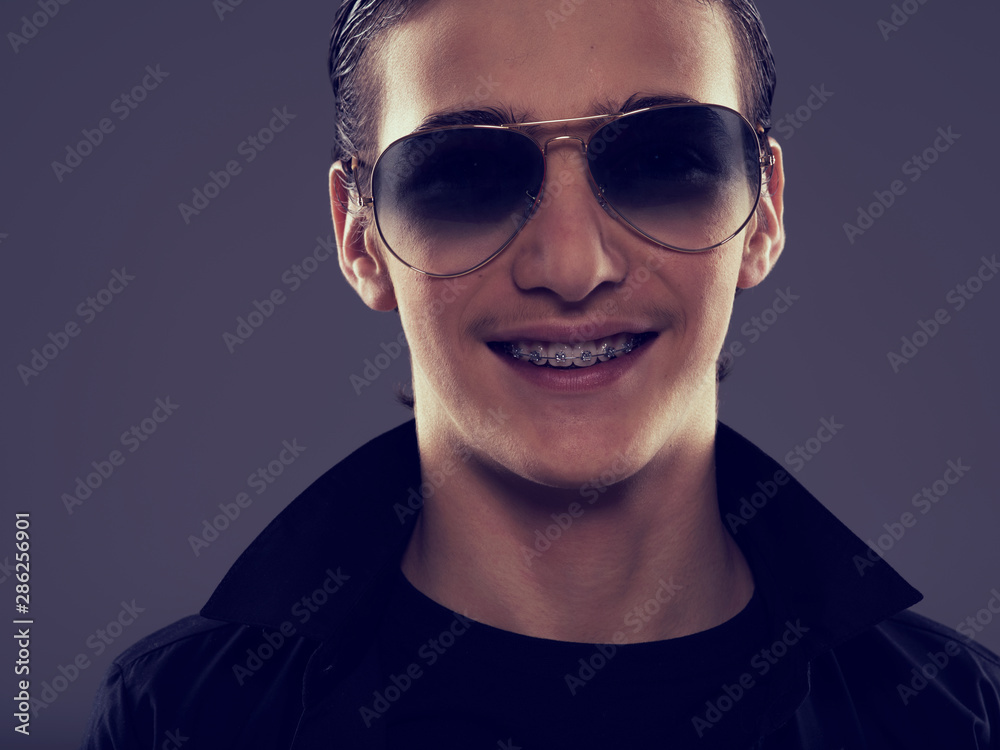 Obraz premium Smiling Handsome fifteen years old guy in a black stylish sunglasses.