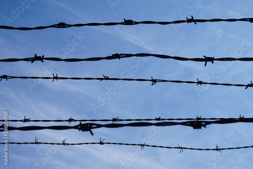 Barbed wire, sky in background - prison/ jail