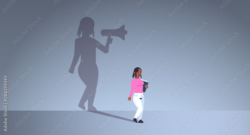 Naklejka african american girl dreaming about being manager or boss screaming in megaphone shadow of business woman with loudspeaker imagination aspiration concept full length flat horizontal