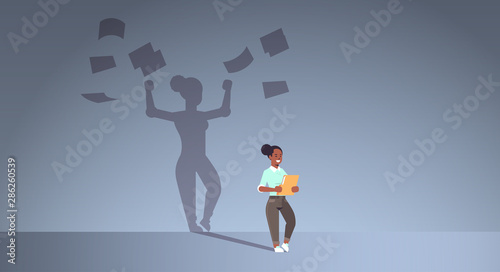 african american businesswoman holding folder shadow of business woman throwing paper documents overvorked aspiration imagination concept full length flat horizontal