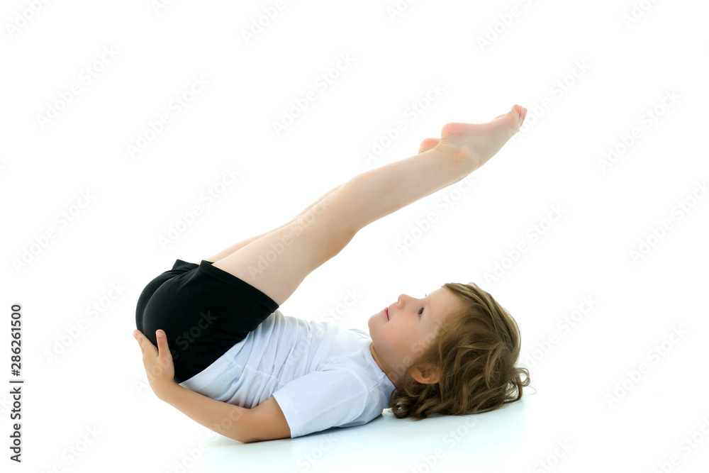 Charming little girl doing gymnastic exercises in the studio on Charming little girl doing gymnastic exercises in the studio on