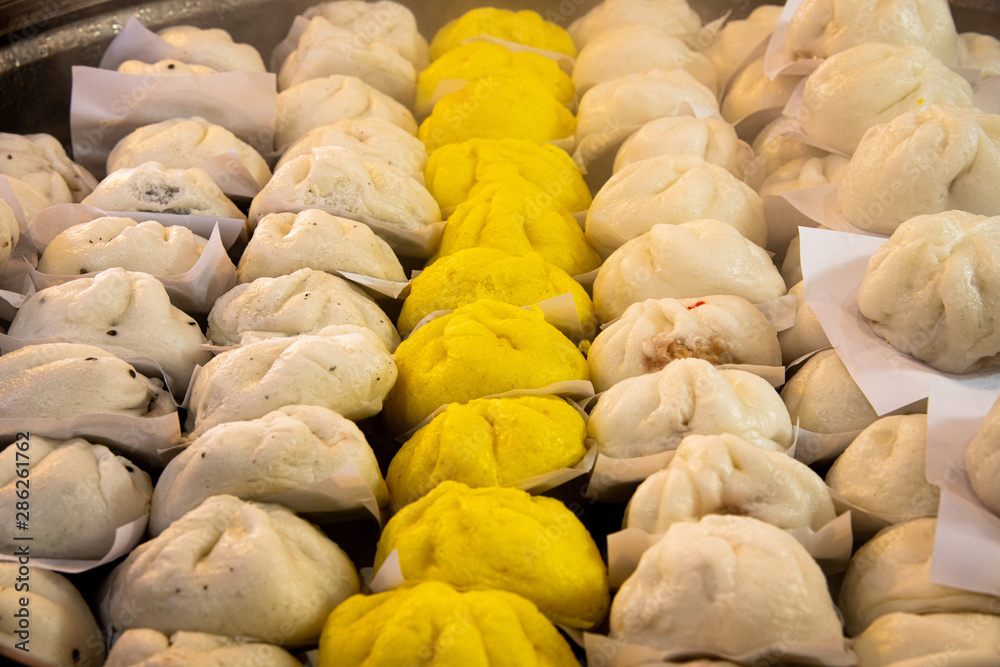 Fototapeta premium Various delicious steamed Chinese buns on steamer.