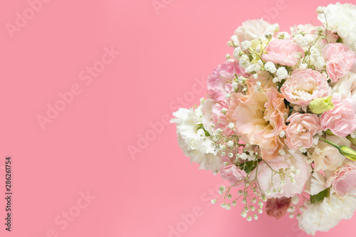 top view of beautiful romantic bouquet fresh spring flower on pink background with copy space © asiandelight