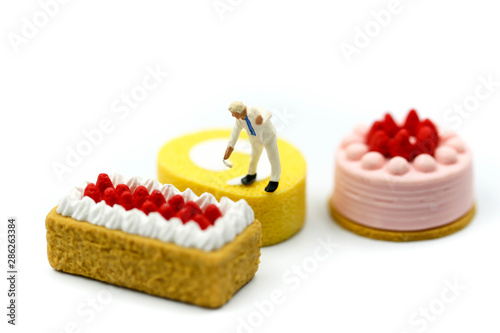 Miniature people : Worker painting with Sweet dessert,cooking and decoration concept.