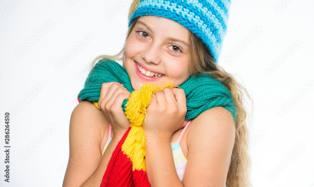 Hat and scarf keep warm. Which fabrics will keep you warmest this winter. Girl long hair happy face white background. Kid wear warm soft knitted blue hat and long scarf. Warm woolen accessories Hat and scarf keep warm. Which fabrics will keep you warmest this winter. Girl long hair happy face white background. Kid wear warm soft knitted blue hat and long scarf. Warm woolen accessories