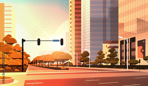 beautifil city street asphalt road with traffic light high skyscraper modern cityscape sunset background flat horizontal closeup