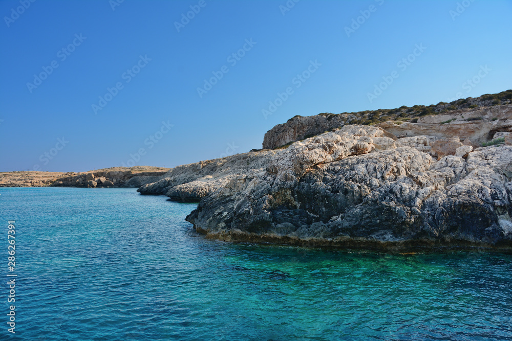 Mediterranean sea and island with rocky cliff Mediterranean sea and island with rocky cliff