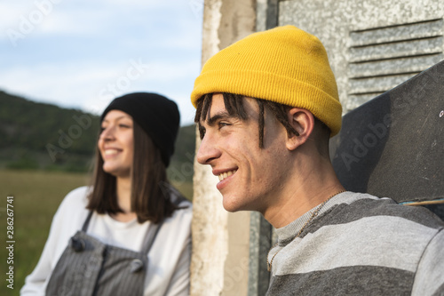 Portrait of a young couple with modern style smiling and happy