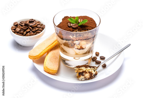 Classic tiramisu dessert in a glass cup on the plate on white background with clipping path
