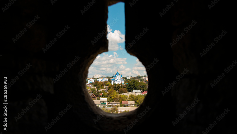 creative cultural and religion picture of Eastern European orthodox church landmark view in castle dark stone loophole with keyhole shape black frame empty space for copy or text