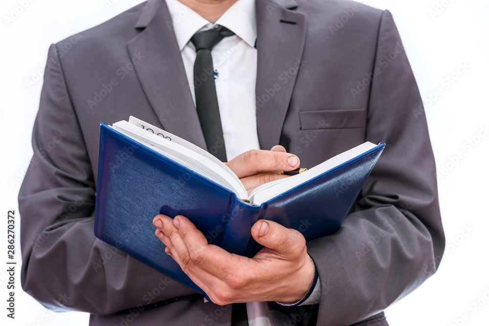 Man writing in diary close up isolated on white