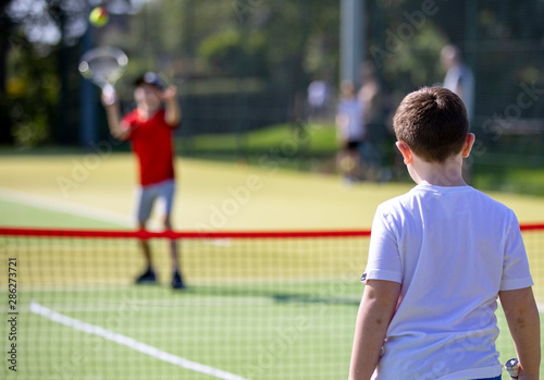close up of boys playing tennis