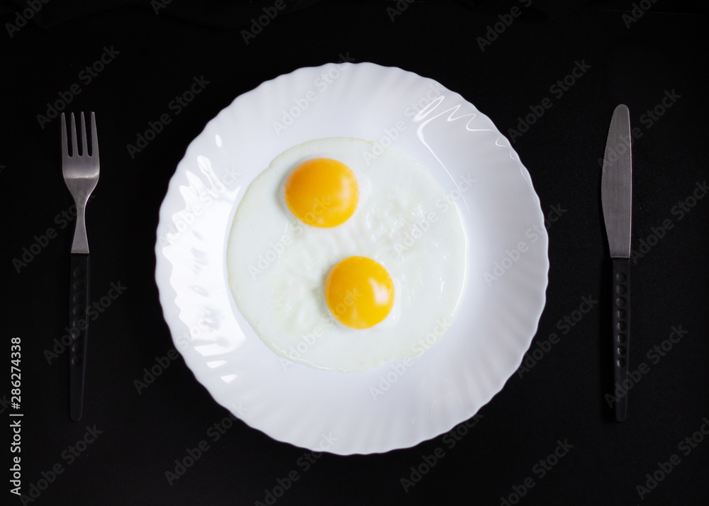 breakfast and light lunch or dinner. on a wooden table and with a black background. eggs cheese butter and coffee in white plate breakfast and light lunch or dinner. on a wooden table and with a black background. eggs cheese butter and coffee in white plate