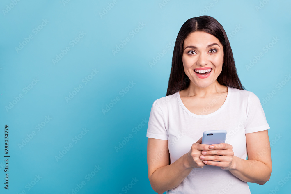 Photo of charming nice cute toothy crazy funny funky girlfriend seeing something unbelievable on her phone while isolated with blue background Photo of charming nice cute toothy crazy funny funky girlfriend seeing something unbelievable on her phone while isolated with blue background
