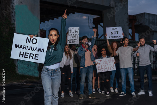 selective focus of woman holding placard with no marijuana lettering near screaming multicultural people © LIGHTFIELD STUDIOS