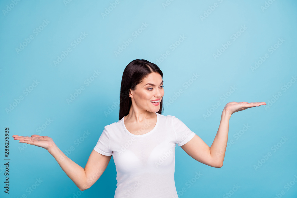 Photo of cute nice good kind beautiful girlfriend showing you something better while isolated with blue background Photo of cute nice good kind beautiful girlfriend showing you something better while isolated with blue background