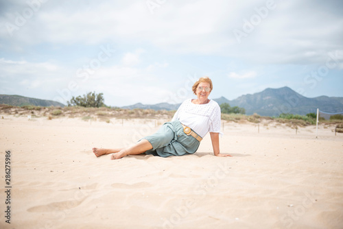 Beautiful mature woman posing on the beach © Noelia