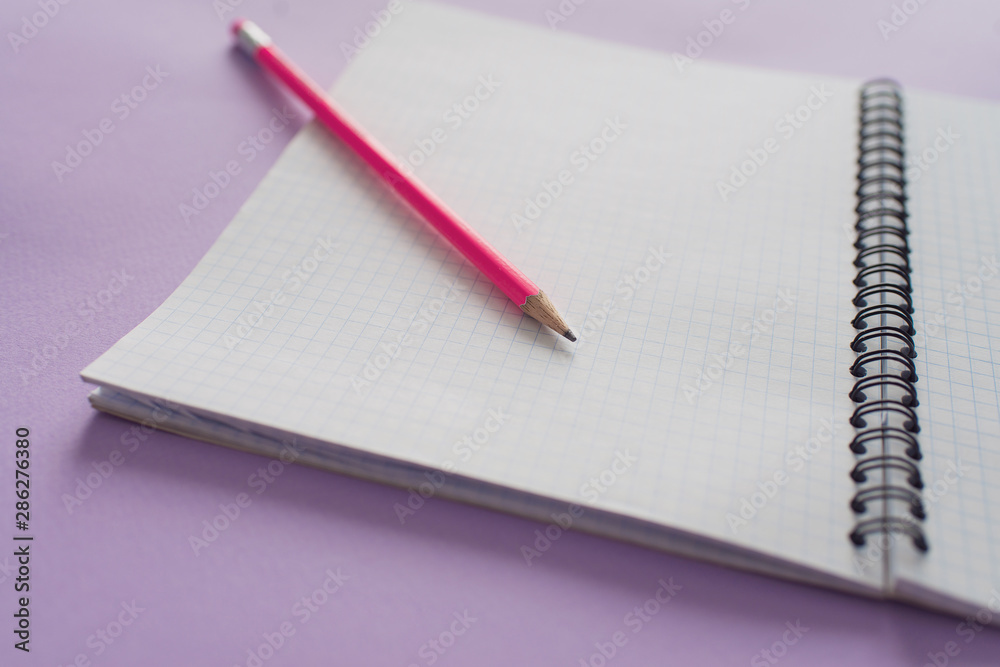 Education concept - pink pencil close up and opened notebook for educational new academic year begin or study.Back to school. Copy space Education concept - pink pencil close up and opened notebook for educational new academic year begin or study.Back to school. Copy space