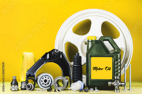 Set of car parts for maintenance or tuning on red background photo