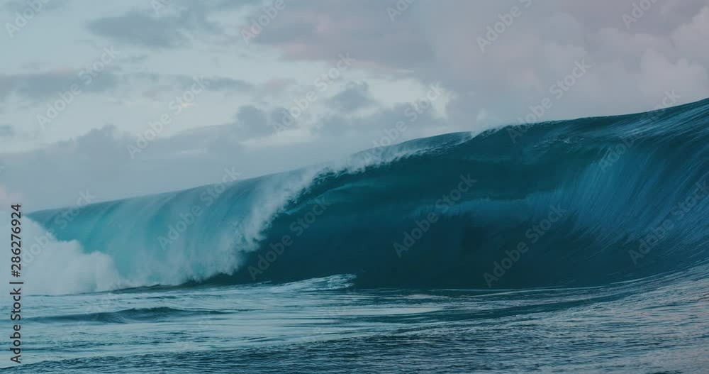 SUPER SLOW MOTION: Giant glassy blue ocean wave breaking and barreling with spray SUPER SLOW MOTION: Giant glassy blue ocean wave breaking and barreling with spray