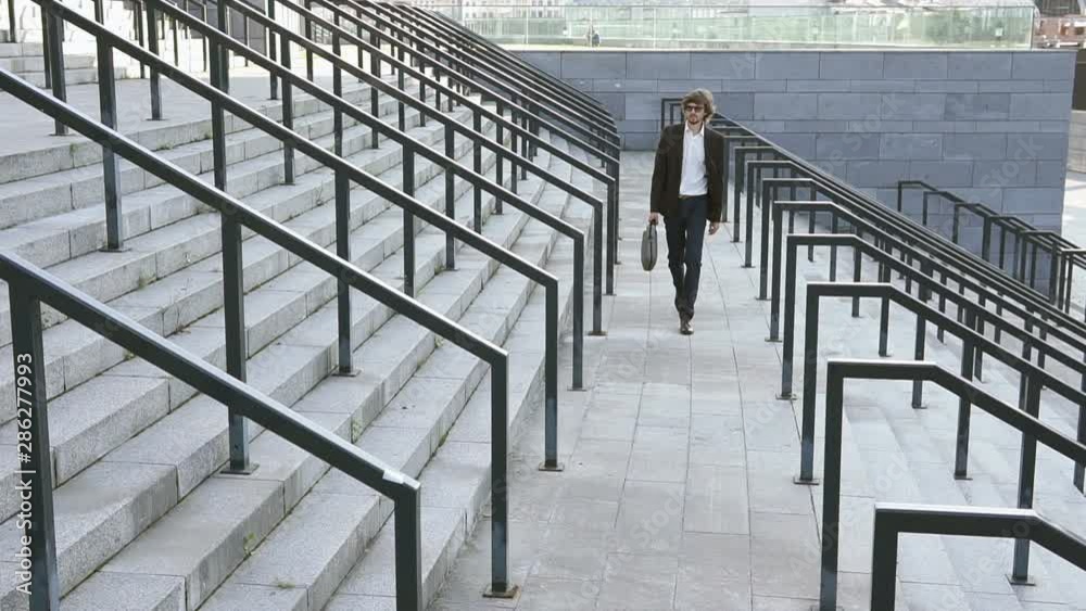 Young successful businessman on his way to work in the big city Young successful businessman on his way to work in the big city