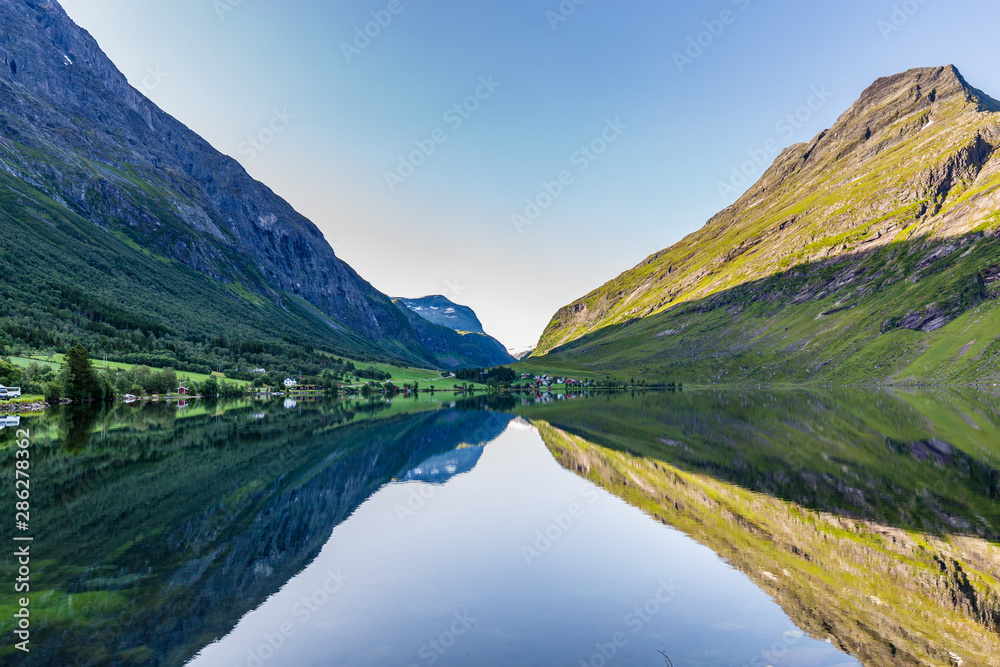Moutains reflecting in the water of lake Eidsvatnet in Eidsdal along national scenic road 63, Trondelag county in Norway