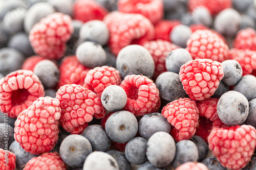 Frozen berries raspberry and blueberry. Macro. Selective focus  shallow depth of field.