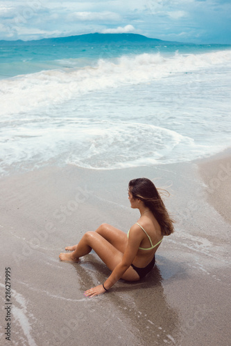 Girl sitting by the shore #286279995