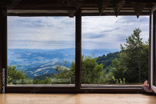 Mountains, view from the window of a wooden house