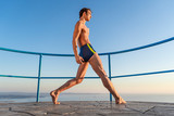Young beautiful male ballett dancer posing by the sea