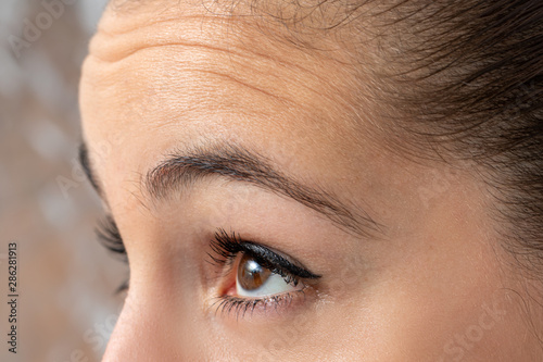 Detail of female frowning forehead .