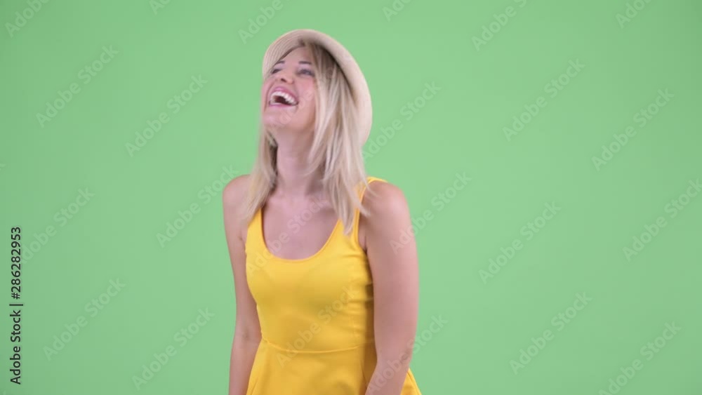 Happy young blonde tourist woman smiling and laughing Happy young blonde tourist woman smiling and laughing
