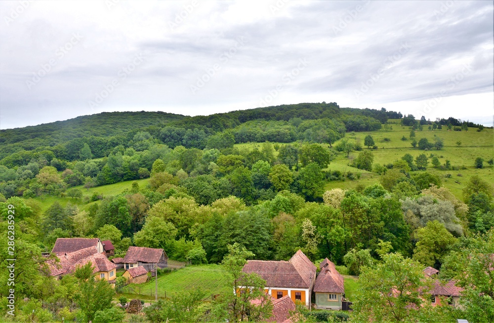 landscape with an old village between the hills