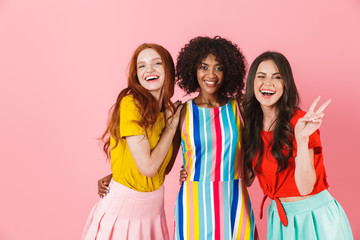 Three lovely young girls wearing summer outfit standing
