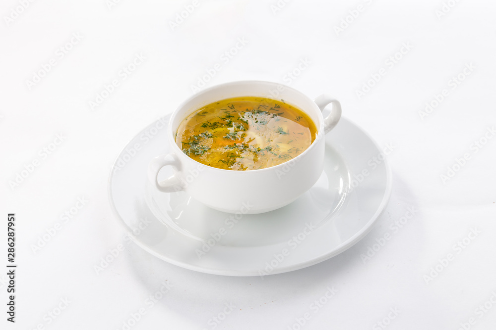 chicken broth with meatballs and herbs in bowl isolated on white background chicken broth with meatballs and herbs in bowl isolated on white background