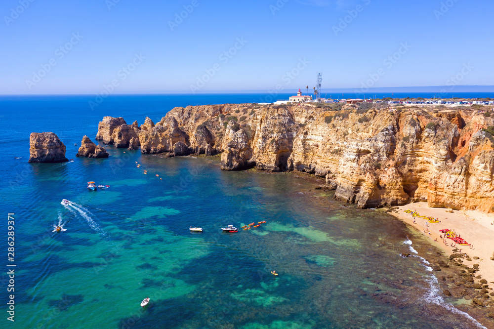 Aerial from natural rocks and the lighthouse at Ponte Piedade in Lagos Portugal