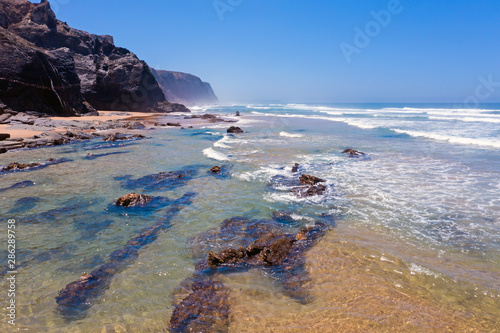 Aerial from the beach and ocean at Praia Vale Figueiras in Portugal photo