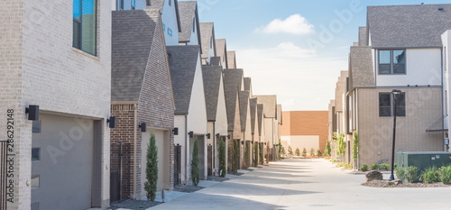 Panoramic large back alley of brand new three story houses community near downtown Dallas